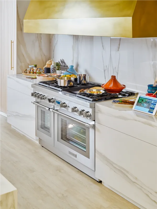 Thermador 48-inch range with griddle in white gold kitchen