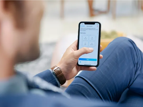 thermador luxury custom panel dishwashers man holding phone using home connect app