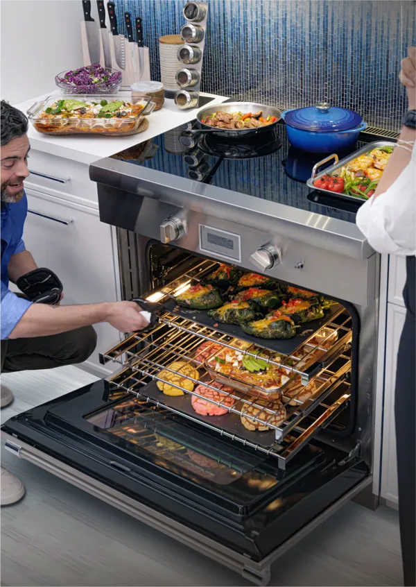 thermador pro harmony induction range couple in blue tiled kitchen
