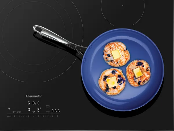 Thermador Heritage Induction cooktop with blue pan and blueberry pancakes