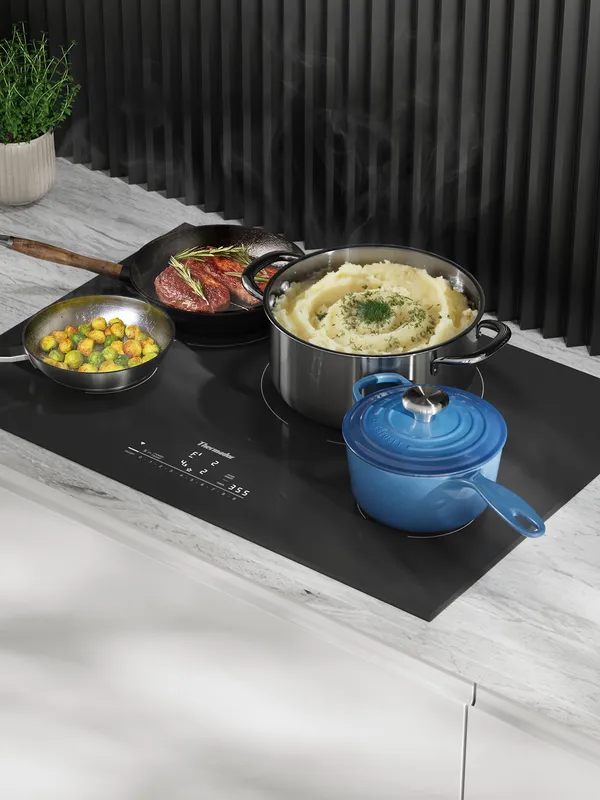 Thermador heritage induction cooktops with pots pan and blue dutch oven