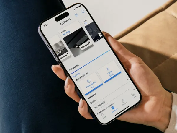 thermador contact us connected experience phone in hand