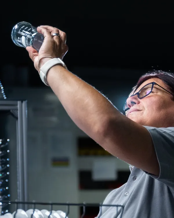 Quality employee checking a spotless drinking glass