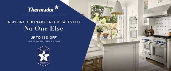 Modern white kitchen with large island, gold fixtures, blue knob stove, and open doors revealing a garden, alongside a Thermador promotion in French.