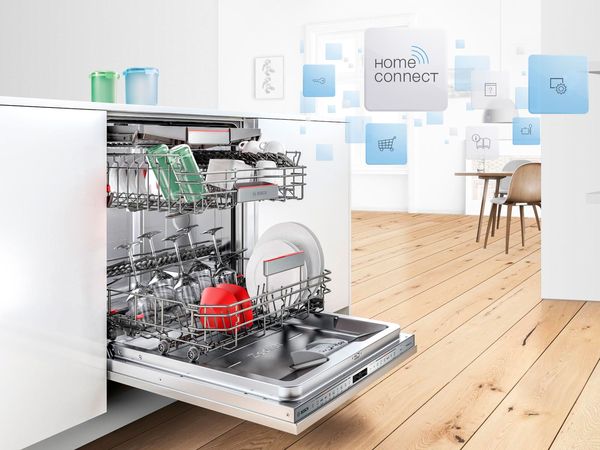 An open dishwasher with a Home Connect function.