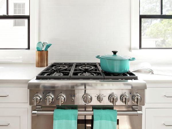 Thermador 36 inch range with teal towels dutch oven and kitchenware 