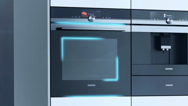 Siemens iQ700 oven with blue light beam graphic overlays.