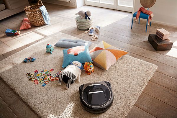 Home Connect Vacuum Cleaner Robot cleans around the toys in the children's room.