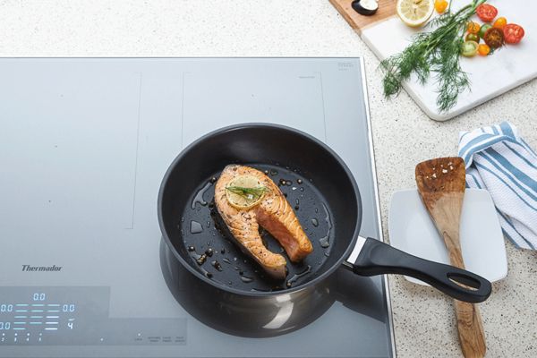 Thermador Masterpiece Collection liberty Induction Cooktop with salmon in pan 