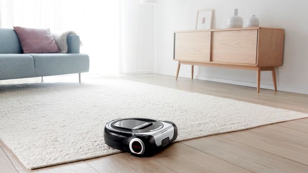 A robot vacuum cleaner in a light, tidy home 