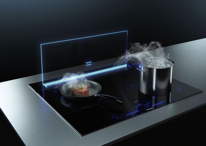Pot and pan on hob with steam coming out going down into glassdraftAir