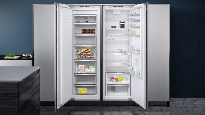Side by side cooling appliances with doors open showing full inside contents