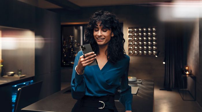 Woman holding a mobile phone smiling