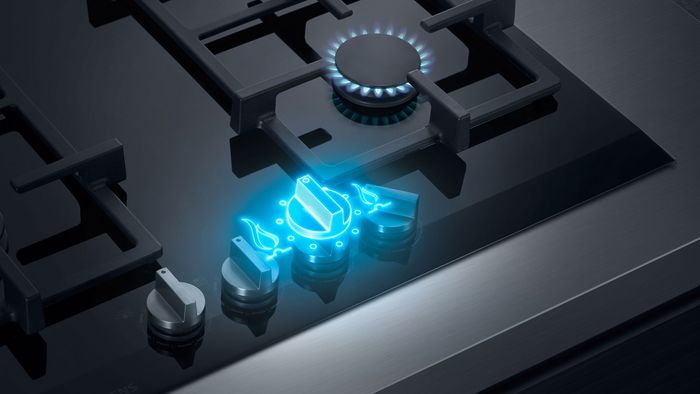 Futurystyczny piec gazowy z niebieskimi płomieniami i metalicznymi elementami w ciemnym otoczeniu.