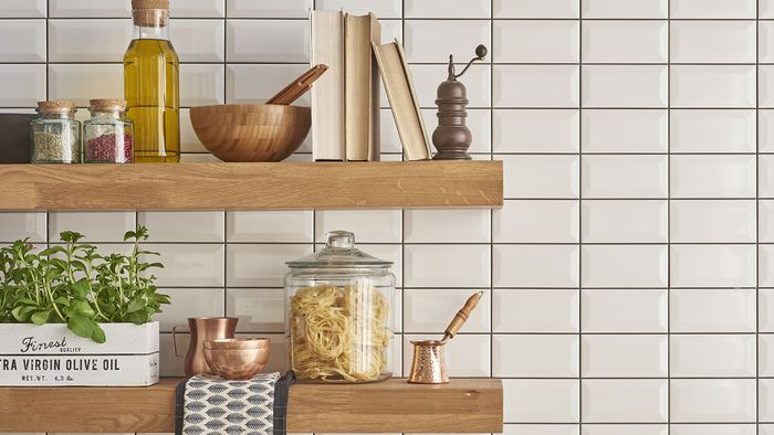 Open wooden shelving with numerous items on top