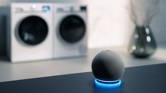 An amazon echo with a Siemens washer and dryer in the background