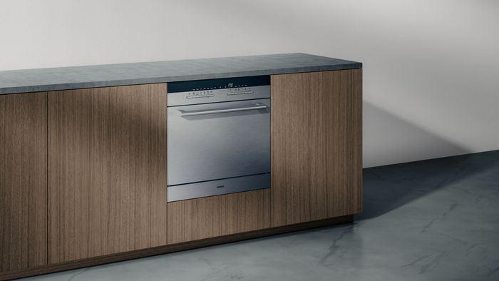 מטבח עם חזיתות עץ מתוכנן ומצויד במדיח כלים מובנה איכותי.          