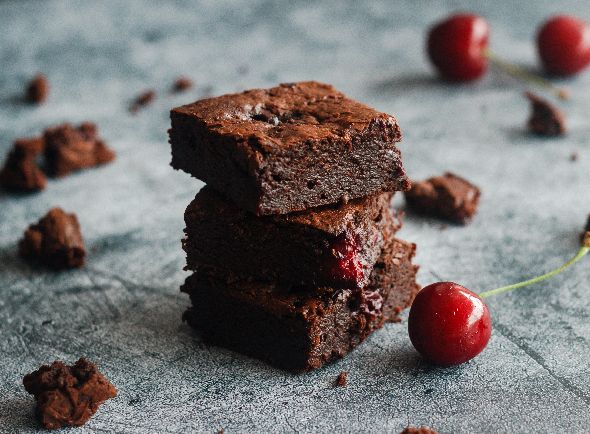 Slic of chocolate cherry tray bake.