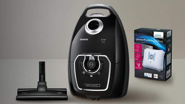 Staubsauger, Staubbeutel, Reinigungszubehör, schwarzes und weißes Farbschema, Haushaltsgerät.