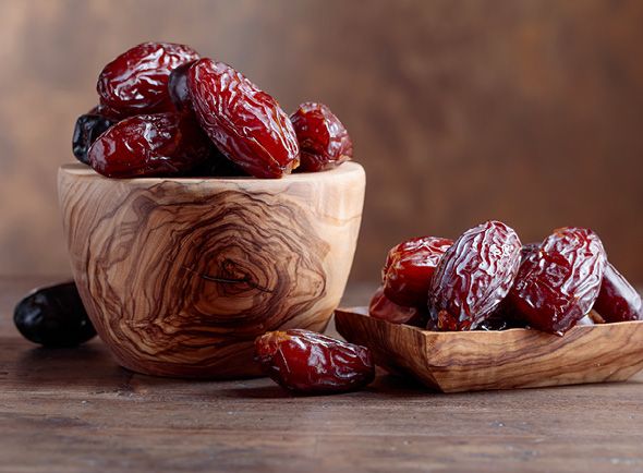 Mejdool dates in a wooden bowl