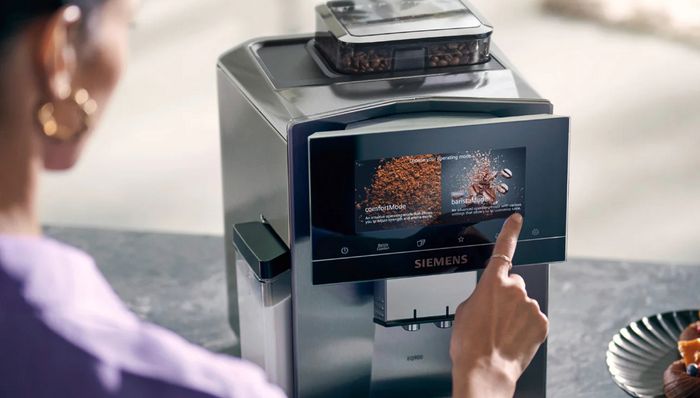 Person using EQ900 coffee machine