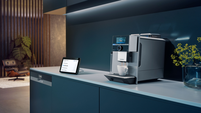 A Siemens coffee machine next to a amazon echo show