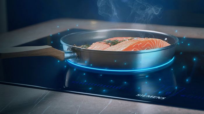 Cooking sensor hob with graphic overlay showing sound form frying pan with bacon wrapped tuna steaks