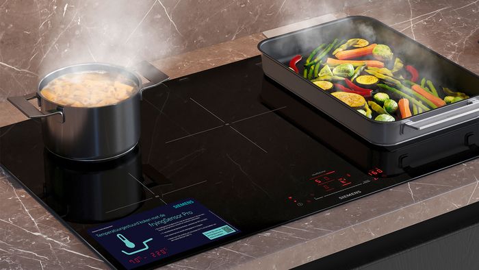 Different food cooking in different pan types on induction hob