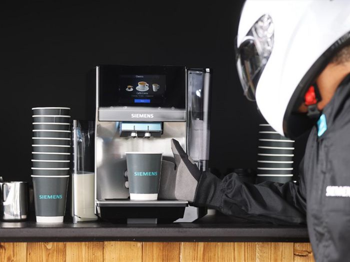 Driver using coffee machine