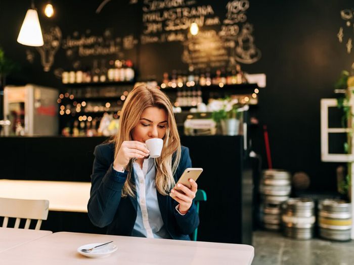 Person drinking coffee in cafe