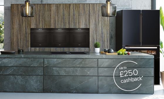 Dark themed spacious kitchen with multiple Siemens appliances