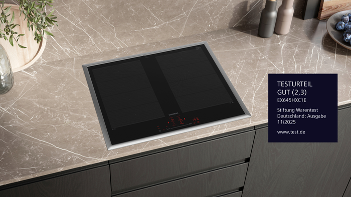 Siemens Induktionskochfeld EX645HXC1E auf einer K&uuml;chenarbeitsplatte aus Marmor mit leuchtender roter Touch-Bedienung. Stiftung Warentest Deutschland &bdquo;GUT (2,3)&ldquo; aus Ausgabe 11/2025 sichtbar &ndash; getestet wurden 10 Induktionskochfelder.