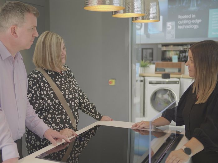 Couple talking to advisor at home of innovation