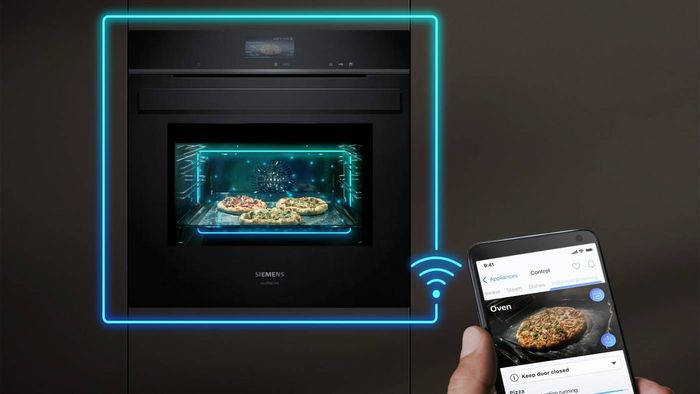 Person using Home Connect app on mobile to check on progress of what's cooking in oven