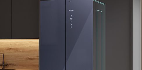 A dark blue Siemens refrigerator integrated into a modern kitchen, with a glowing green line on its side.