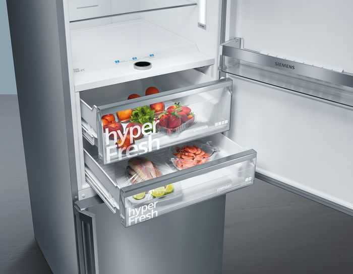 Siemens Fridge freezer with fridge door and hyperfresh drawers open containing produce.