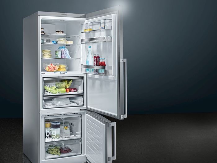 High capacity Siemens Fridge Freezer with doors open and containing produce.
